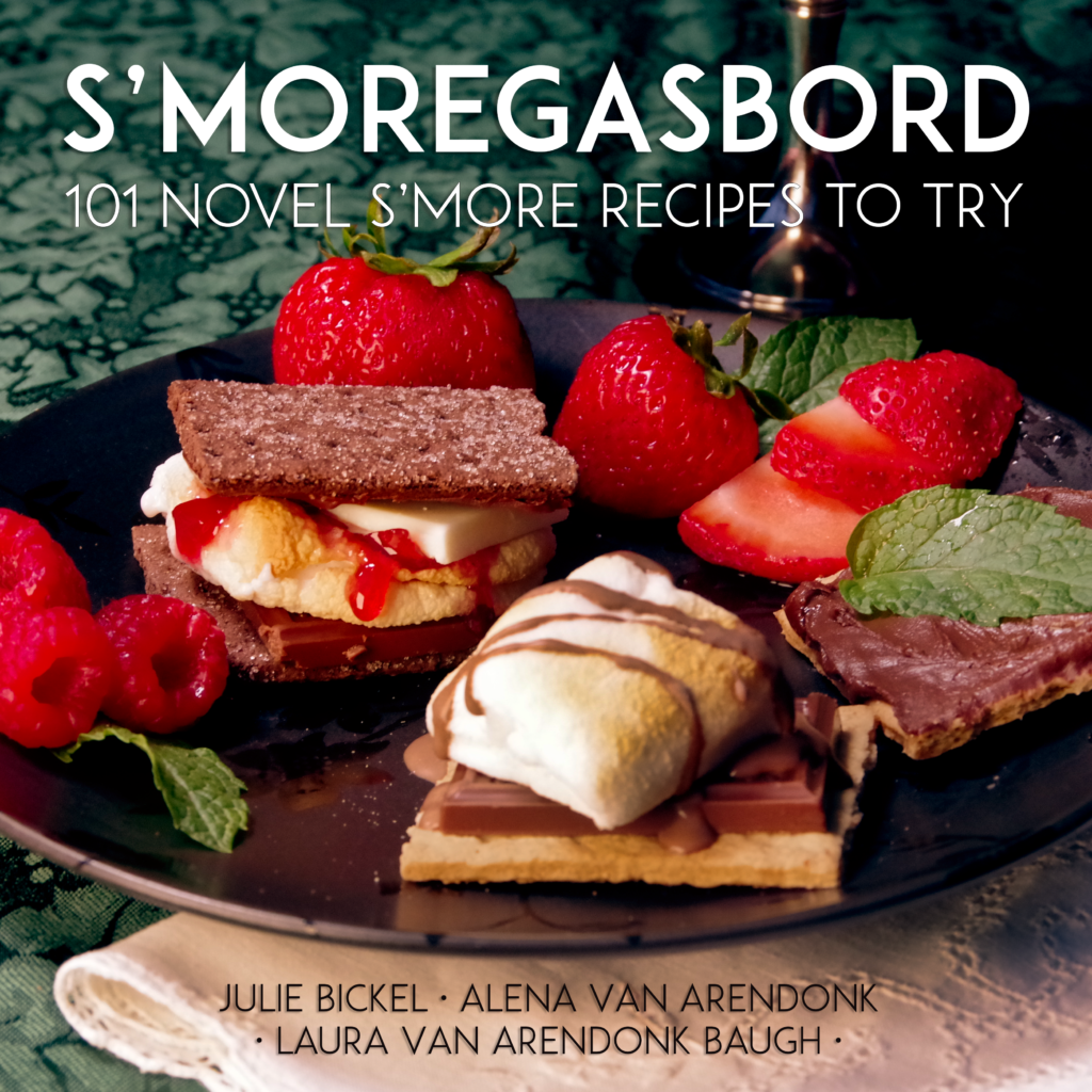 A close-up of three s’mores made with different ingredients, including chocolate, marshmallows, and fruit, arranged on a green tablecloth with strawberries, raspberries, and mint leaves. Text reads "S’Moregasbord: 101 Novel S’more Recipes to Try.